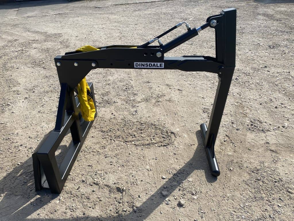 Up and over bale handler attachment for skidsteers lifting bales from above