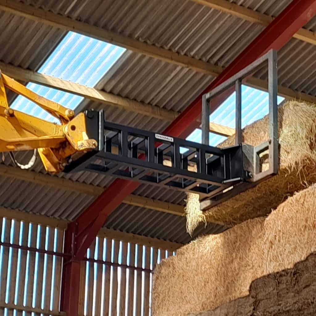 High-quality black loader platform with safety rails, used for accessing elevated areas in barns.
