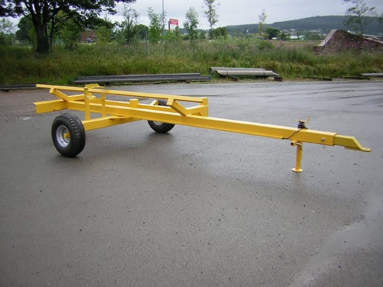 High-quality yellow utility trailer for transporting heavy machinery or materials.