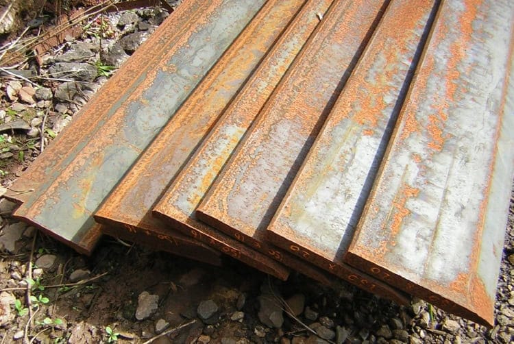 Rusty steel beams for demolition and construction projects. Durable, heavy-duty metal components.